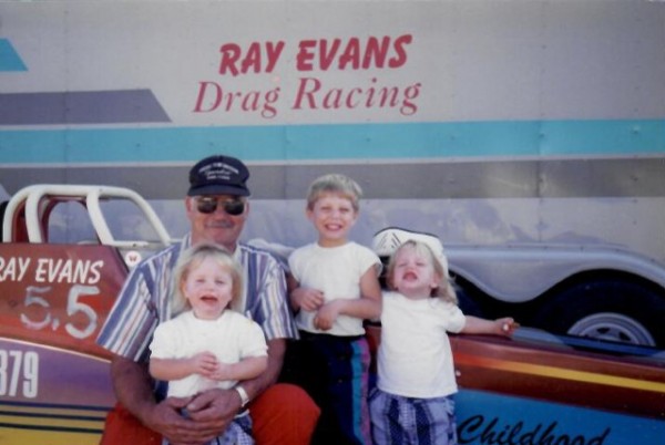 Ray Evans with the kids around their Jr. Dragster